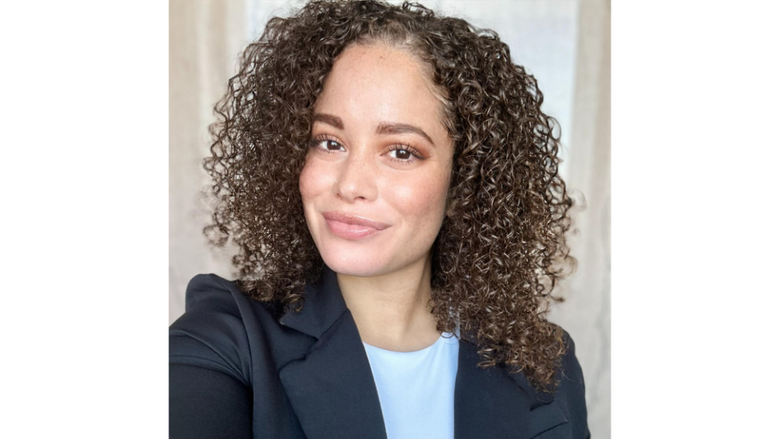 a headshot of a woman in a blazer smiling 